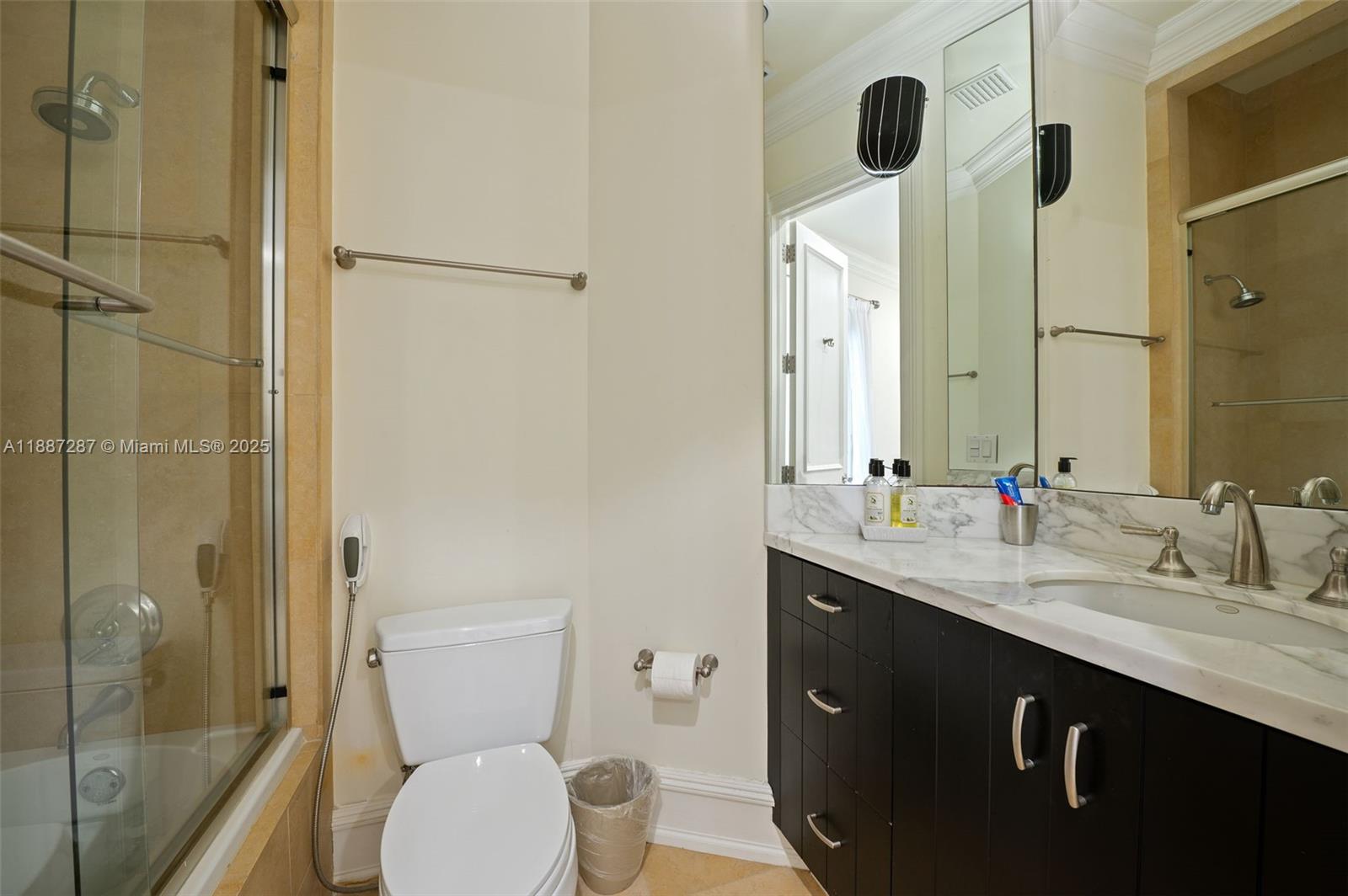 9601 Southwest 60th Court Pinecrest, FL 33156 - Photo 38 of 61 a bathroom with a granite countertop sink toilet and shower