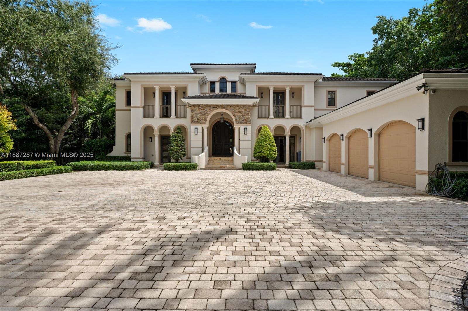 9601 Southwest 60th Court Pinecrest, FL 33156 - Photo 4 of 61 a front view of a house with a yard
