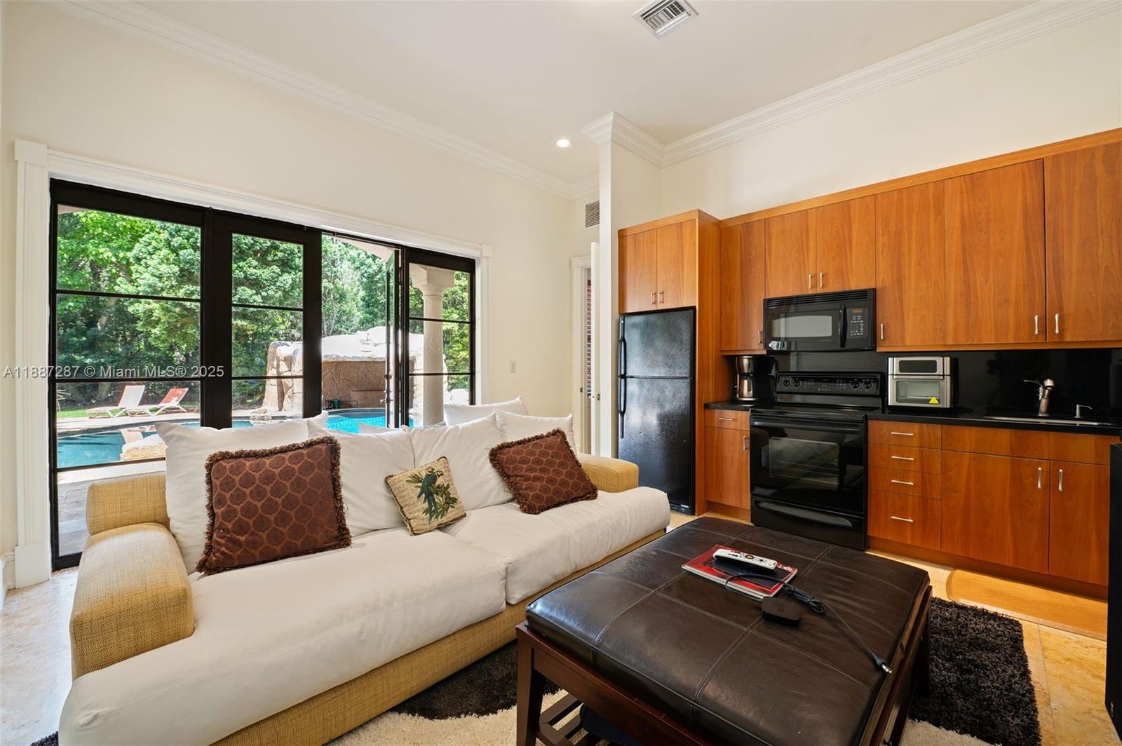 9601 Southwest 60th Court Pinecrest, FL 33156 - Photo 43 of 61 a living room with furniture and a large window