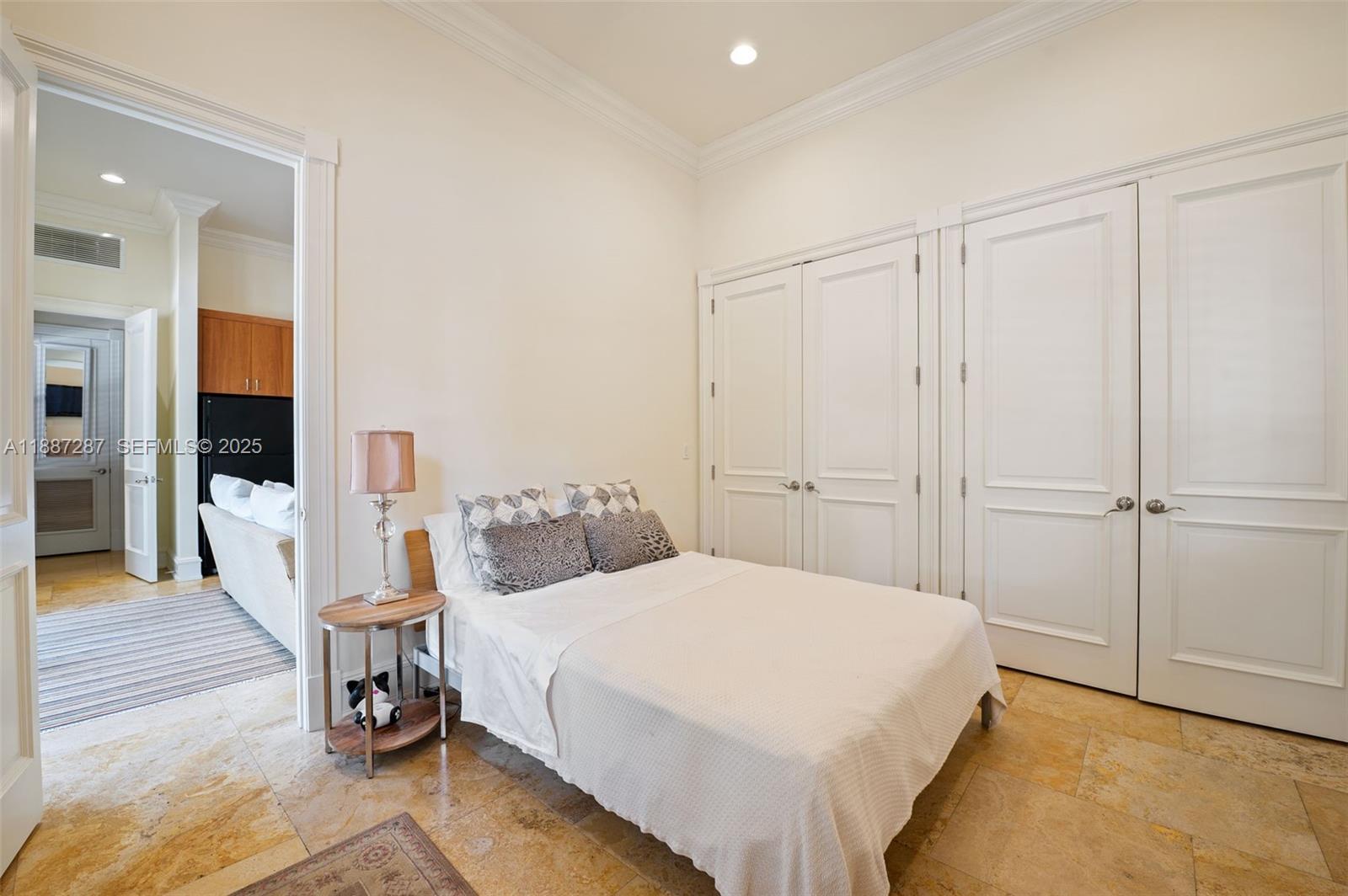 9601 Southwest 60th Court Pinecrest, FL 33156 - Photo 44 of 61 a bedroom with a bed and a view of bathroom