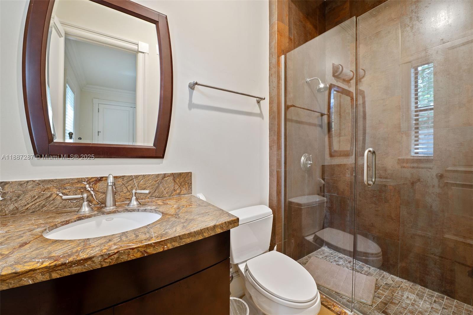 9601 Southwest 60th Court Pinecrest, FL 33156 - Photo 45 of 61 a bathroom with a granite countertop sink toilet and shower