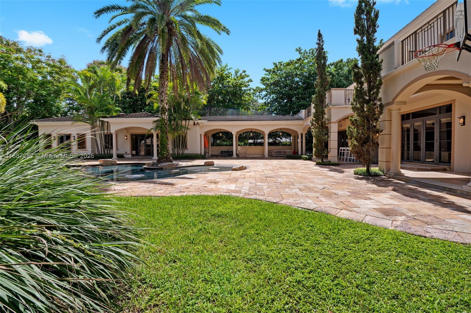 9601 Southwest 60th Court Pinecrest, FL 33156 - Photo 58 of 61 a view of a house with swimming pool and sitting area