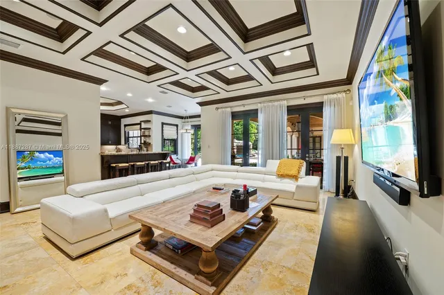 a dining room with furniture a chandelier and wooden floor