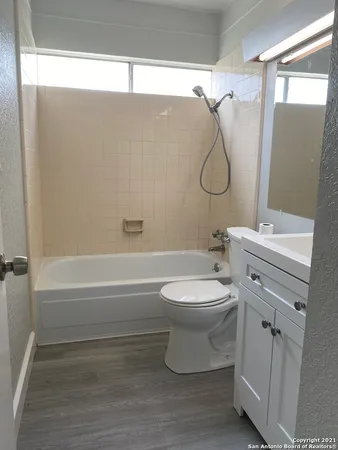 a bathroom with a toilet sink and shower