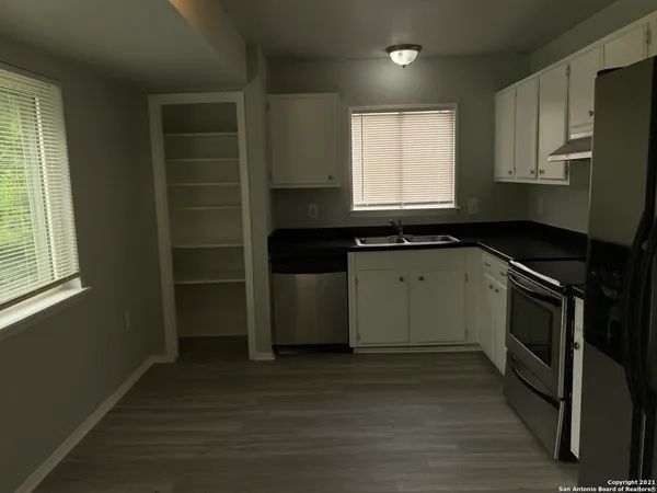 a kitchen with a sink stove and cabinets