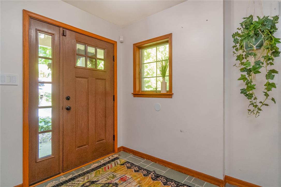 1325 Granger Road Northampton, PA 18067 - Photo 14 of 61 A well-lit entry features a wood-paneled door with sidelight and a cheerful window, creating an inviting first impression.