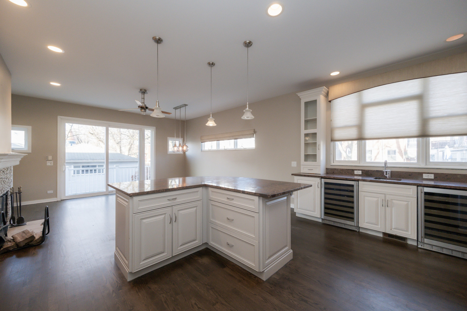 1701 West Byron Street Chicago, IL 60613 - Photo 13 of 57 a kitchen with stainless steel appliances granite countertop a sink a stove and a wooden floor