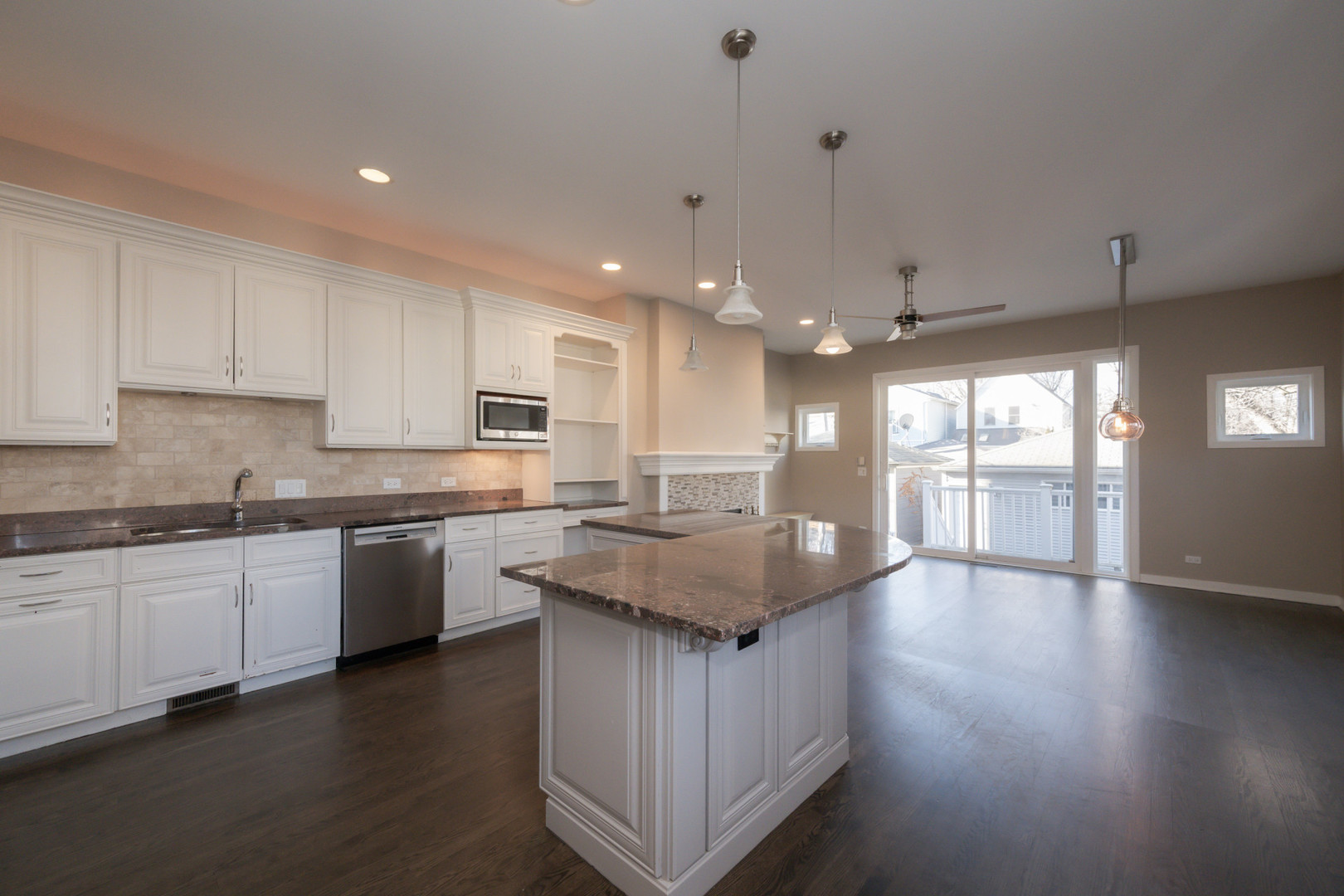 1701 West Byron Street Chicago, IL 60613 - Photo 14 of 57 a kitchen with stainless steel appliances granite countertop a stove a sink and a refrigerator