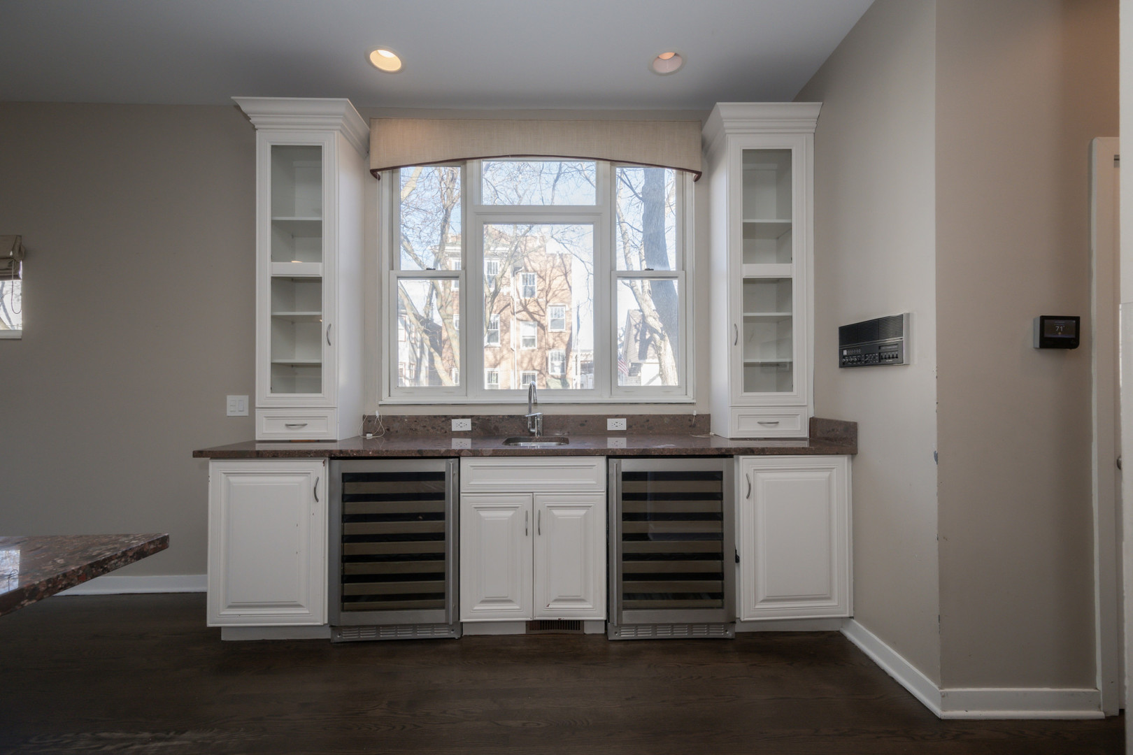 1701 West Byron Street Chicago, IL 60613 - Photo 15 of 57 an open kitchen with granite countertop a stove and a sink