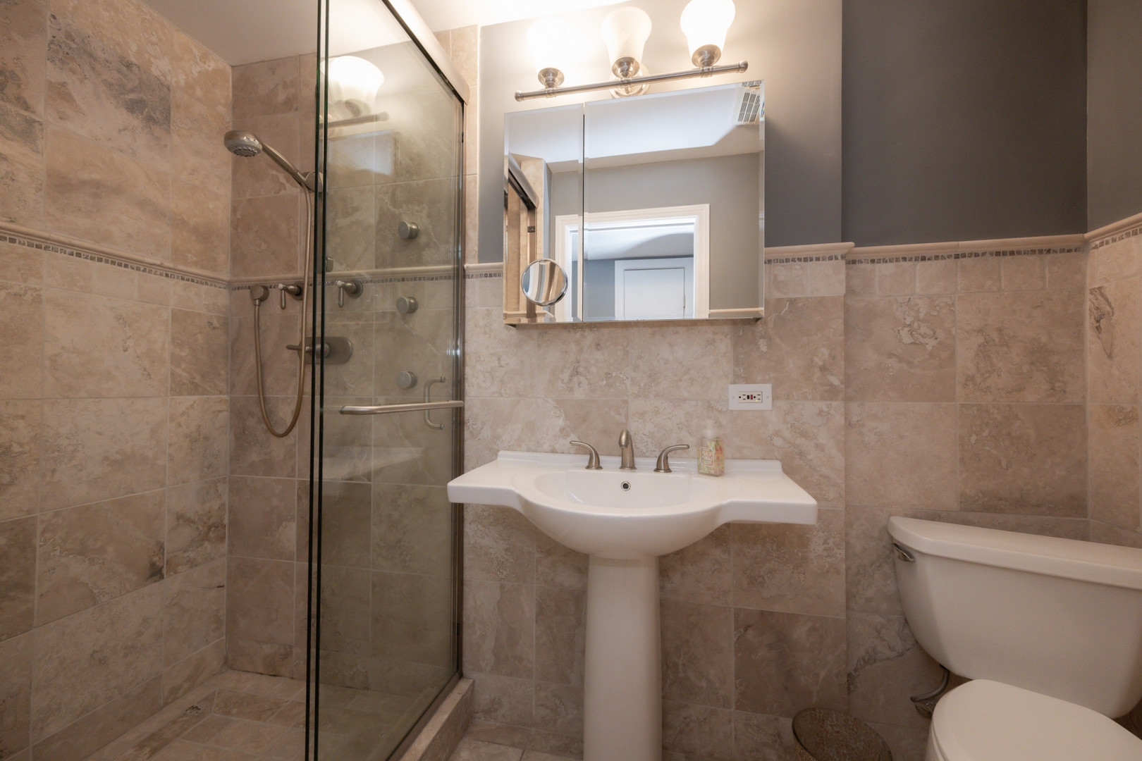 1701 West Byron Street Chicago, IL 60613 - Photo 46 of 57 a bathroom with a sink mirror toilet and shower