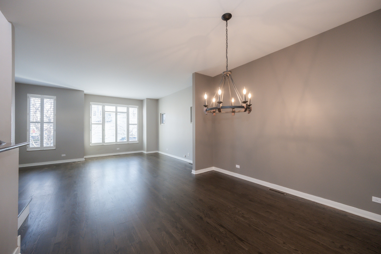 1701 West Byron Street Chicago, IL 60613 - Photo 7 of 57 a view of a room with wooden floor chandelier and windows