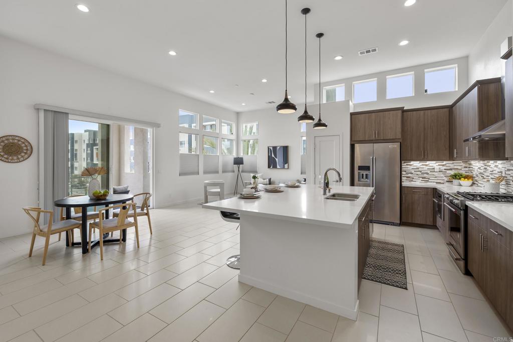 a large kitchen with a table and chairs