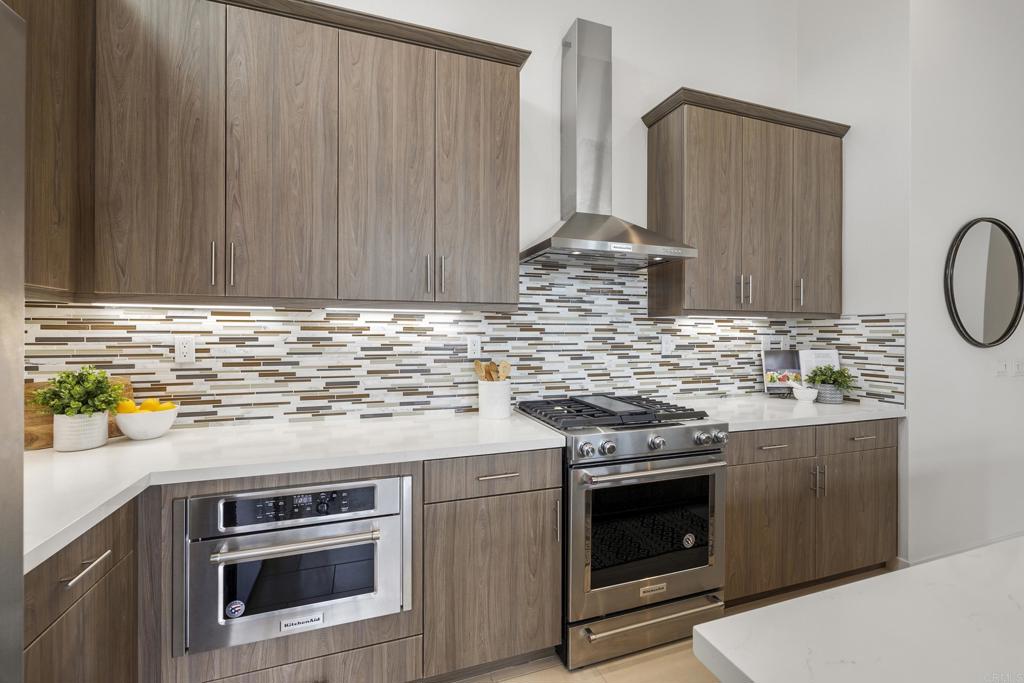 2026 Tango Loop, Unit 3 Chula Vista, CA 91915 - Photo 12 of 34 a kitchen with granite countertop a stove top oven microwave and cabinets