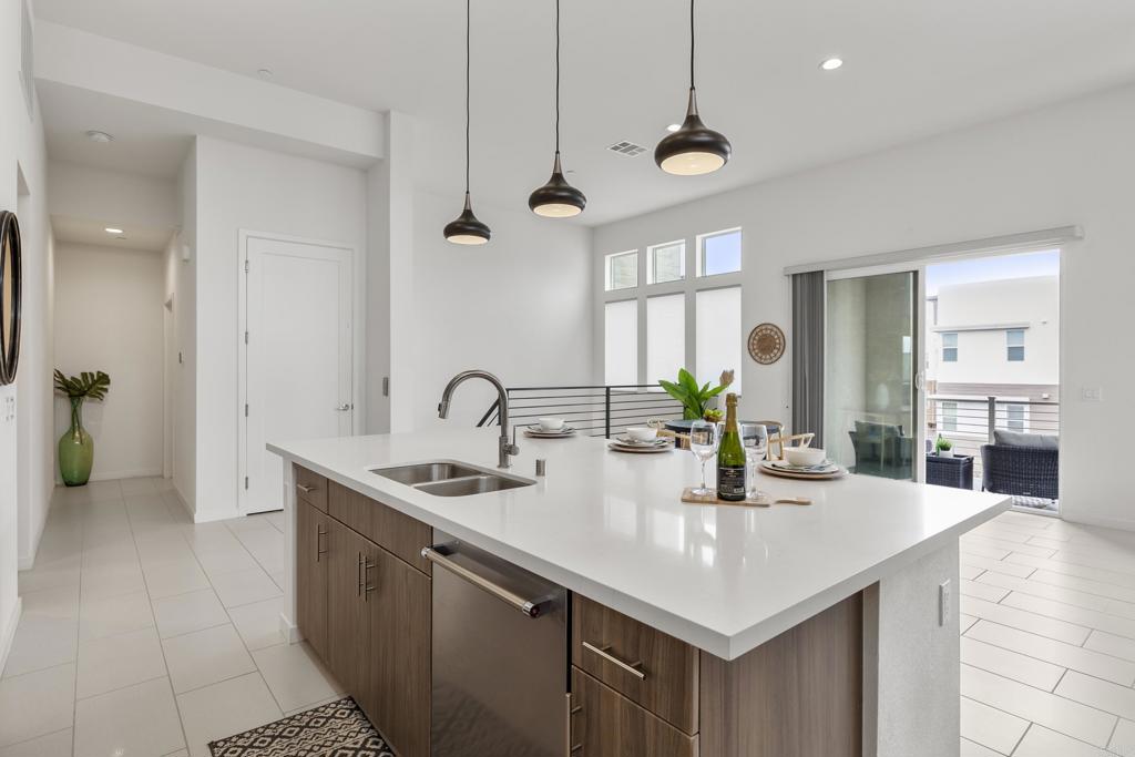 2026 Tango Loop, Unit 3 Chula Vista, CA 91915 - Photo 19 of 34 a kitchen with stainless steel appliances a sink a counter top space cabinets and wooden floor