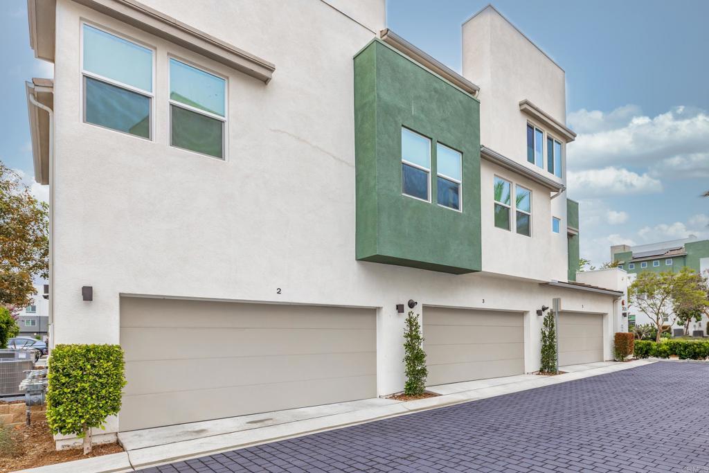 2026 Tango Loop, Unit 3 Chula Vista, CA 91915 - Photo 30 of 34 a front view of a building with a garden