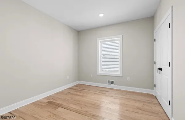 a view of a room with wooden floor and windows