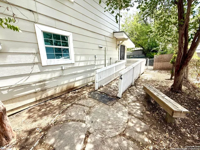 a view of a house with a large tree