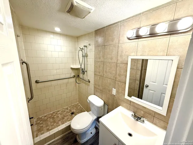 a bathroom with a sink toilet and shower