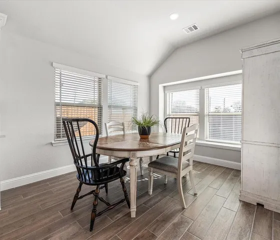 a view of a dining room with furniture and wooden floor