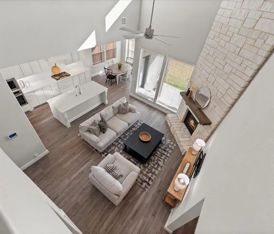 a living room with furniture and floor to ceiling windows