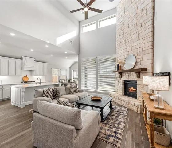 a living room with furniture fireplace and dining table