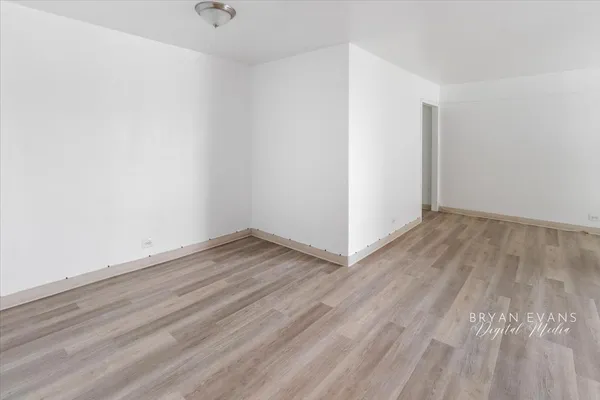 a view of a room with wooden floor