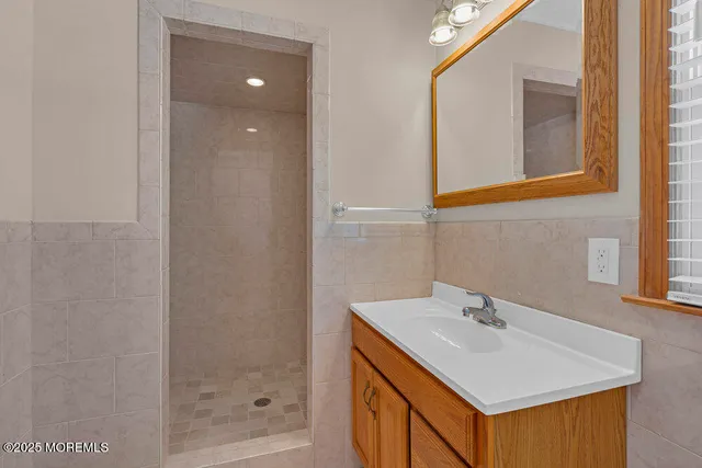 a bathroom with a sink a mirror and a shower