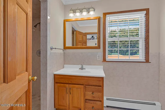 a bathroom with a sink a mirror and a window