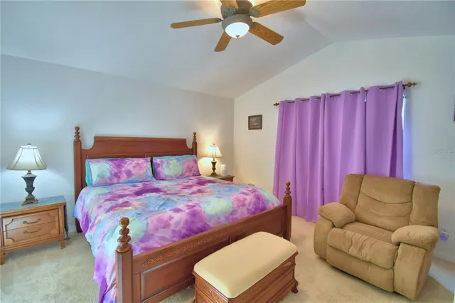 a bedroom with a bed a couch and dresser