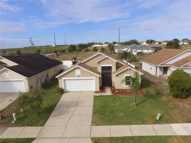 an aerial view of a house with a yard