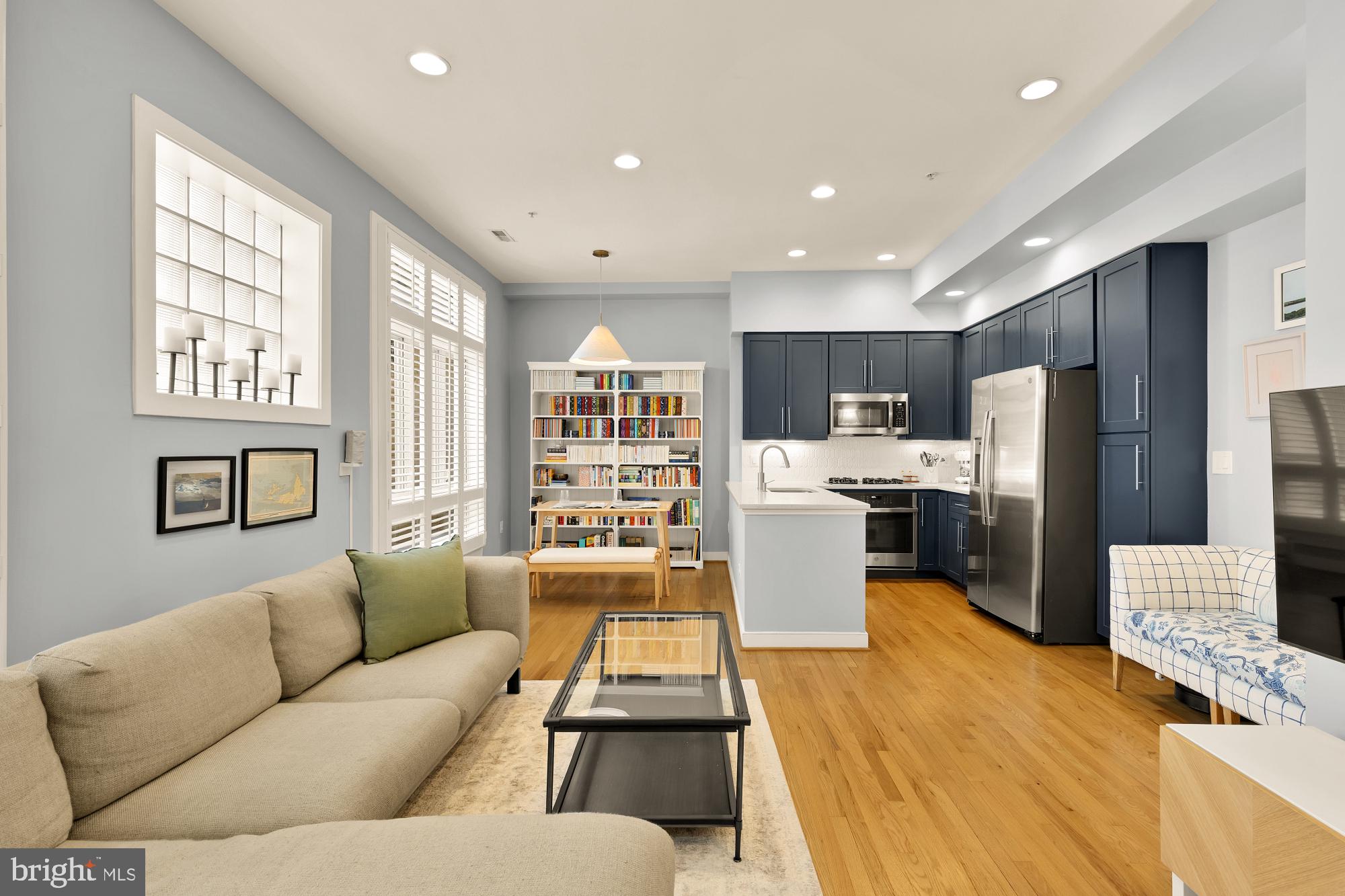2363 Champlain Street Northwest, Unit 26 Washington, DC 20009 - Photo 1 of 35 a living room with stainless steel appliances furniture windows and a kitchen view