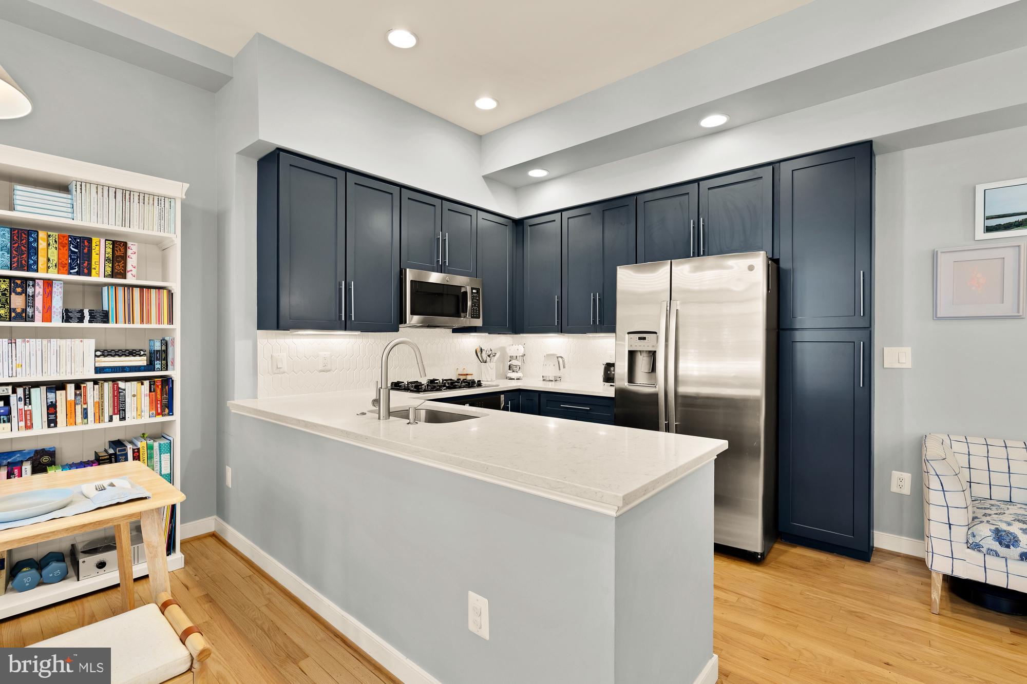 2363 Champlain Street Northwest, Unit 26 Washington, DC 20009 - Photo 12 of 35 a kitchen with stainless steel appliances a refrigerator sink and cabinets