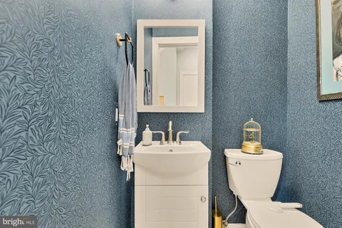 a bathroom with a toilet sink and mirror