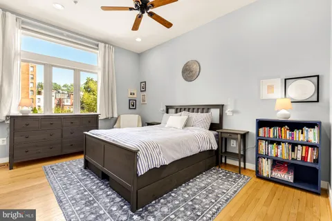 a bedroom with a large bed and a window