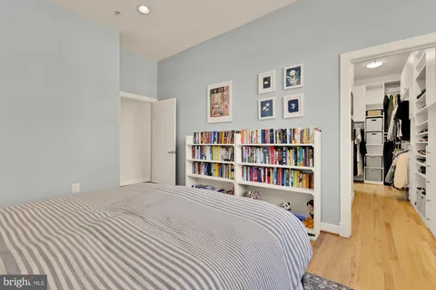 a bedroom with a bed and a book shelf