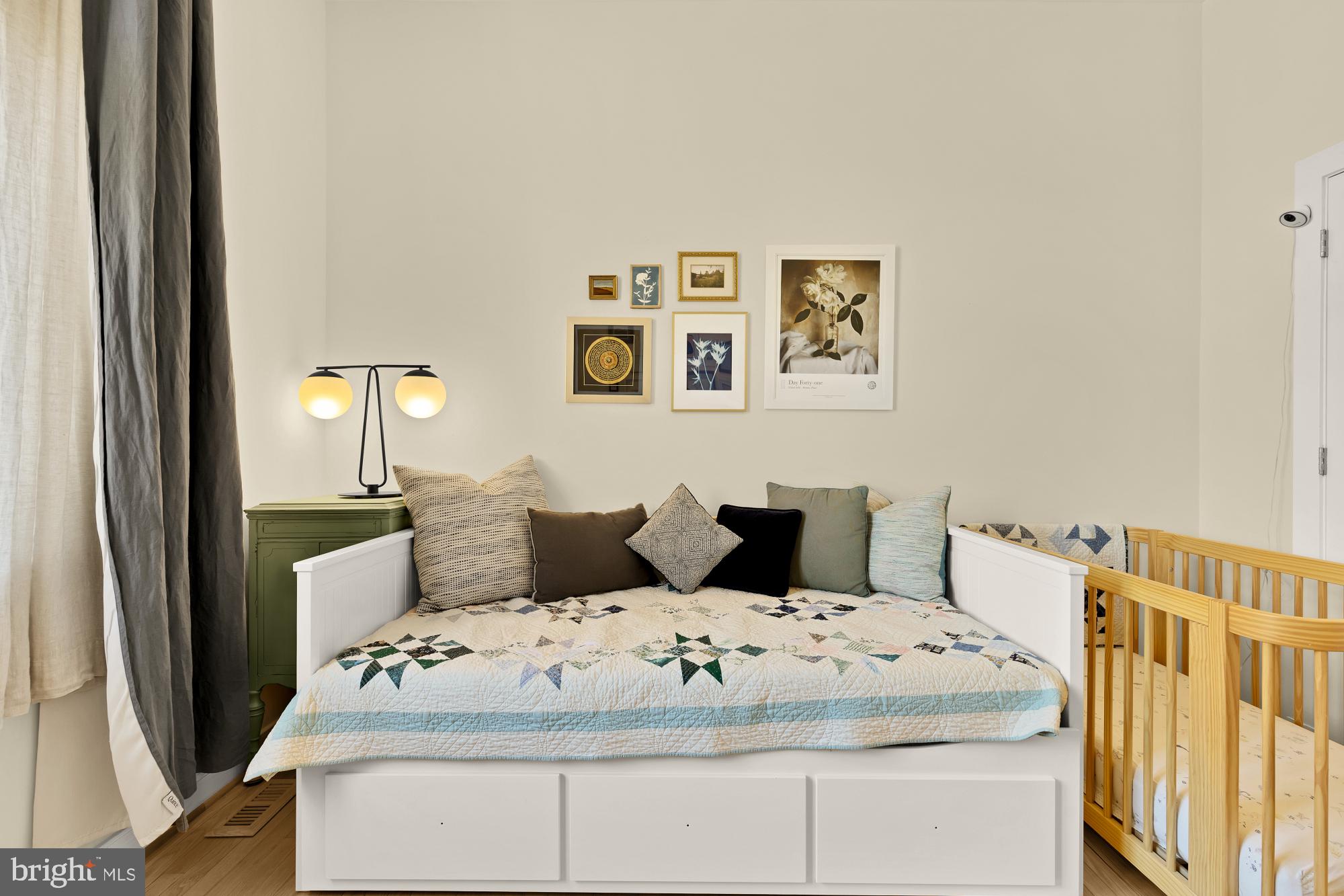 2363 Champlain Street Northwest, Unit 26 Washington, DC 20009 - Photo 28 of 35 a bedroom with a bed and wooden floor