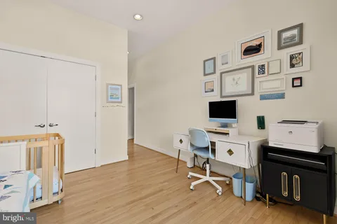 a view of a workspace with furniture and a flat screen tv