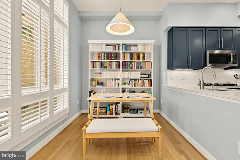 a large white kitchen with a large window