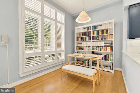 a living room with furniture and a book shelf