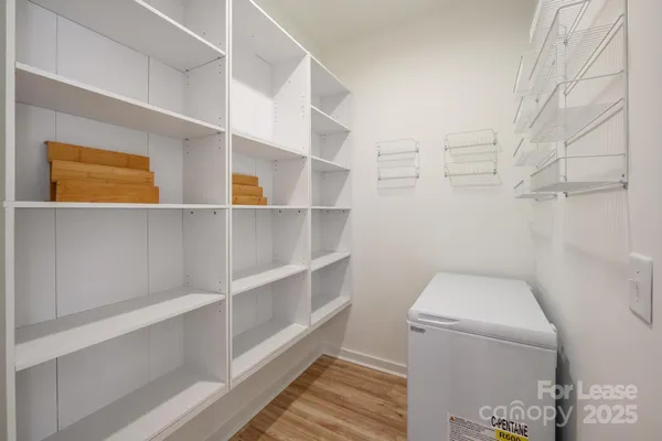 a view of walk in closet with empty racks