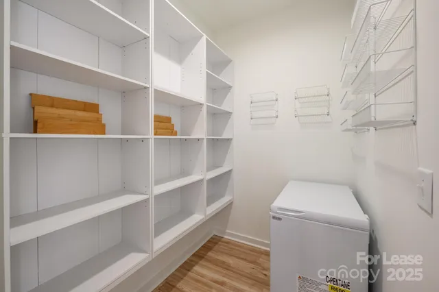 a view of walk in closet with empty racks