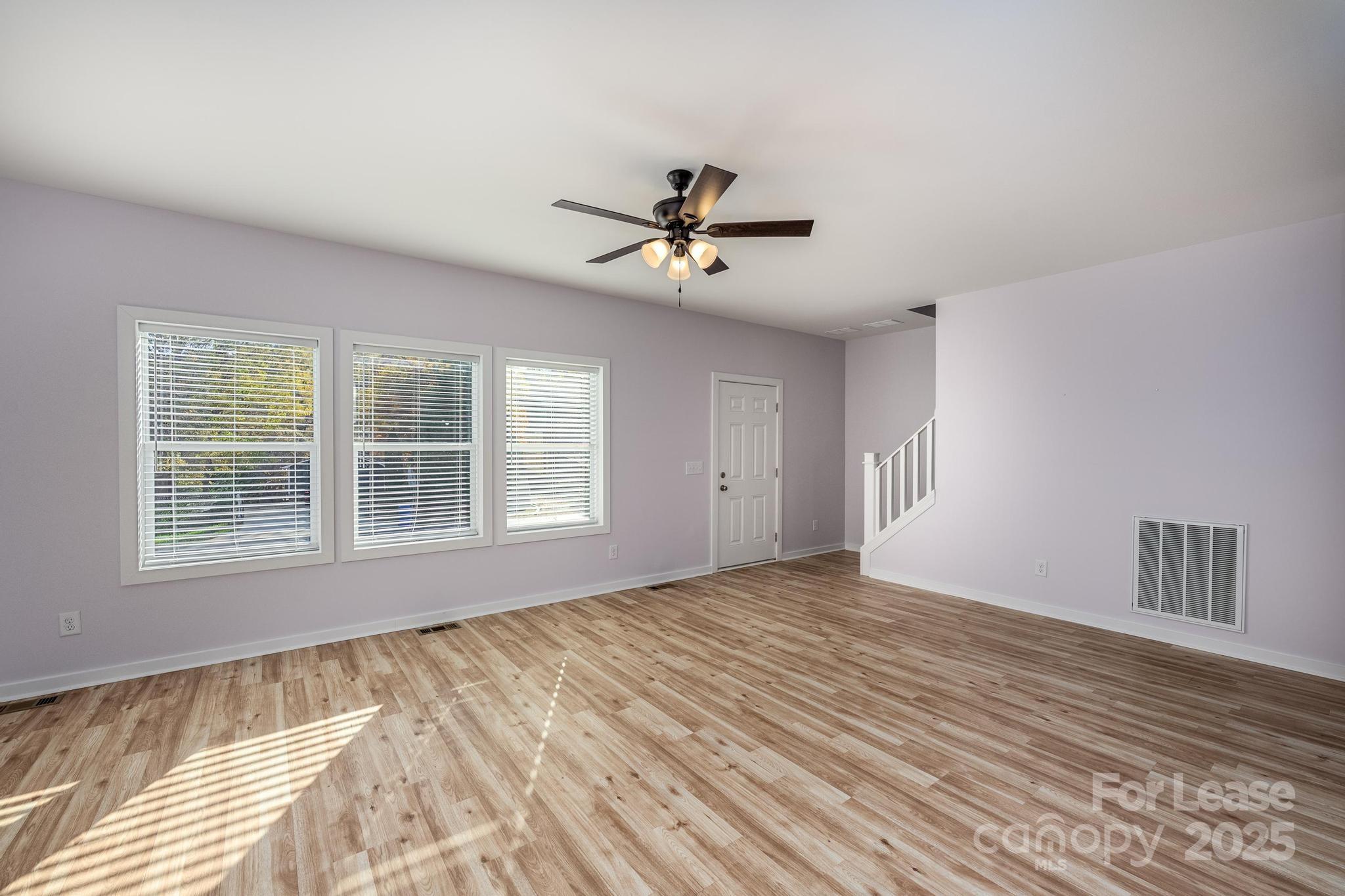 7039 Executive Circle Denver, NC 28037 - Photo 13 of 48 a view of an empty room with a window and a chandelier fan