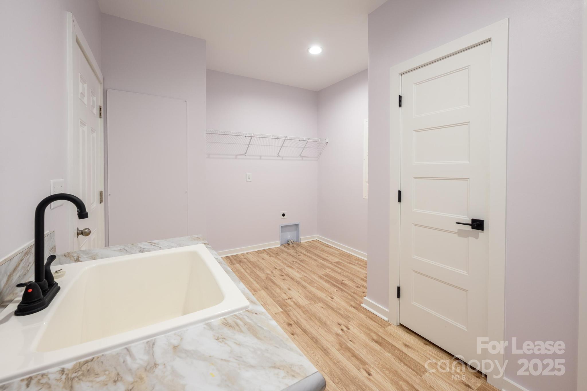 7039 Executive Circle Denver, NC 28037 - Photo 16 of 48 a bathroom with a sink and a mirror