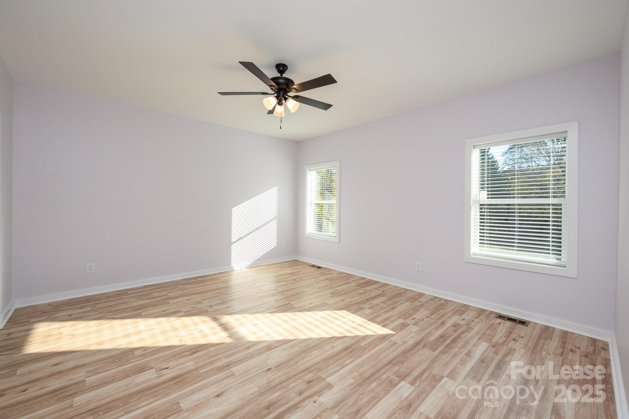 7039 Executive Circle Denver, NC 28037 - Photo 17 of 48 a view of empty room with wooden floor and fan