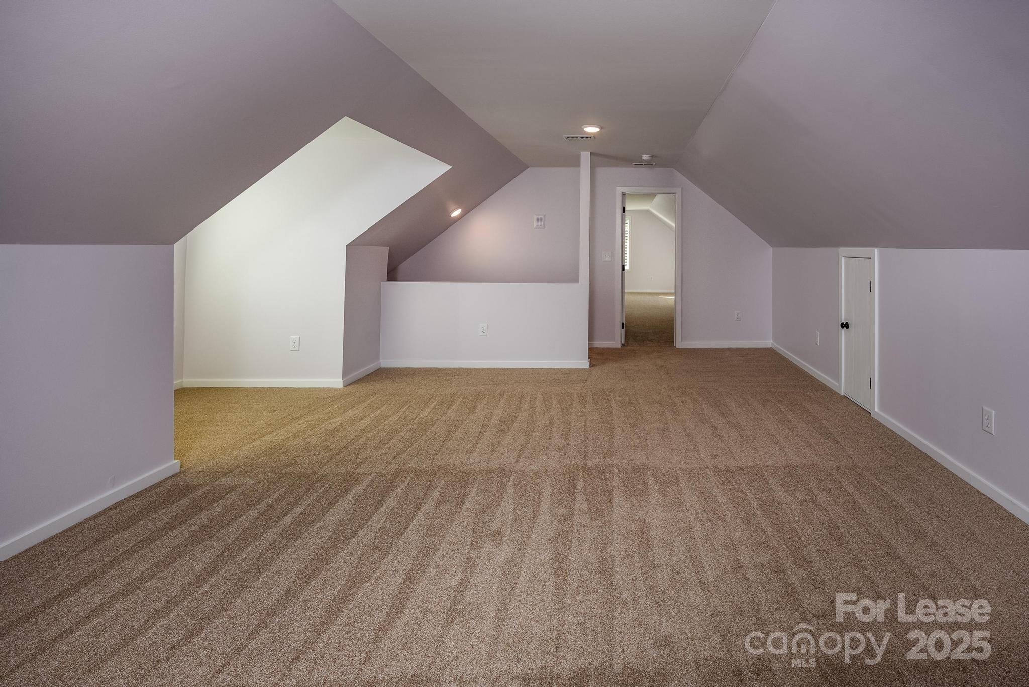 7039 Executive Circle Denver, NC 28037 - Photo 30 of 48 a view of a big room with wooden floor