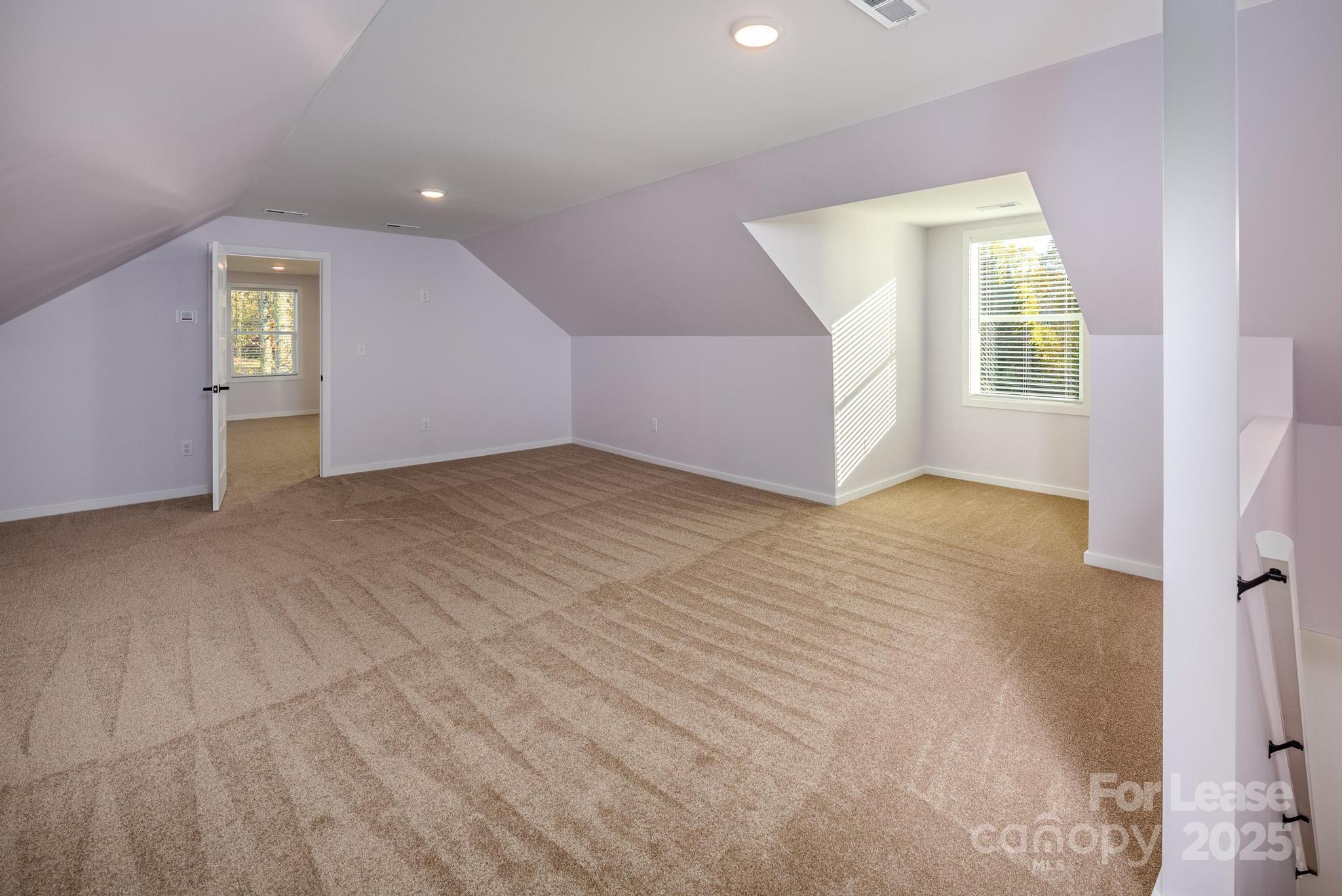 7039 Executive Circle Denver, NC 28037 - Photo 31 of 48 an empty room with windows and closet