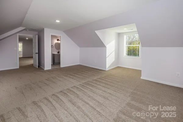 an empty room with windows and entrance