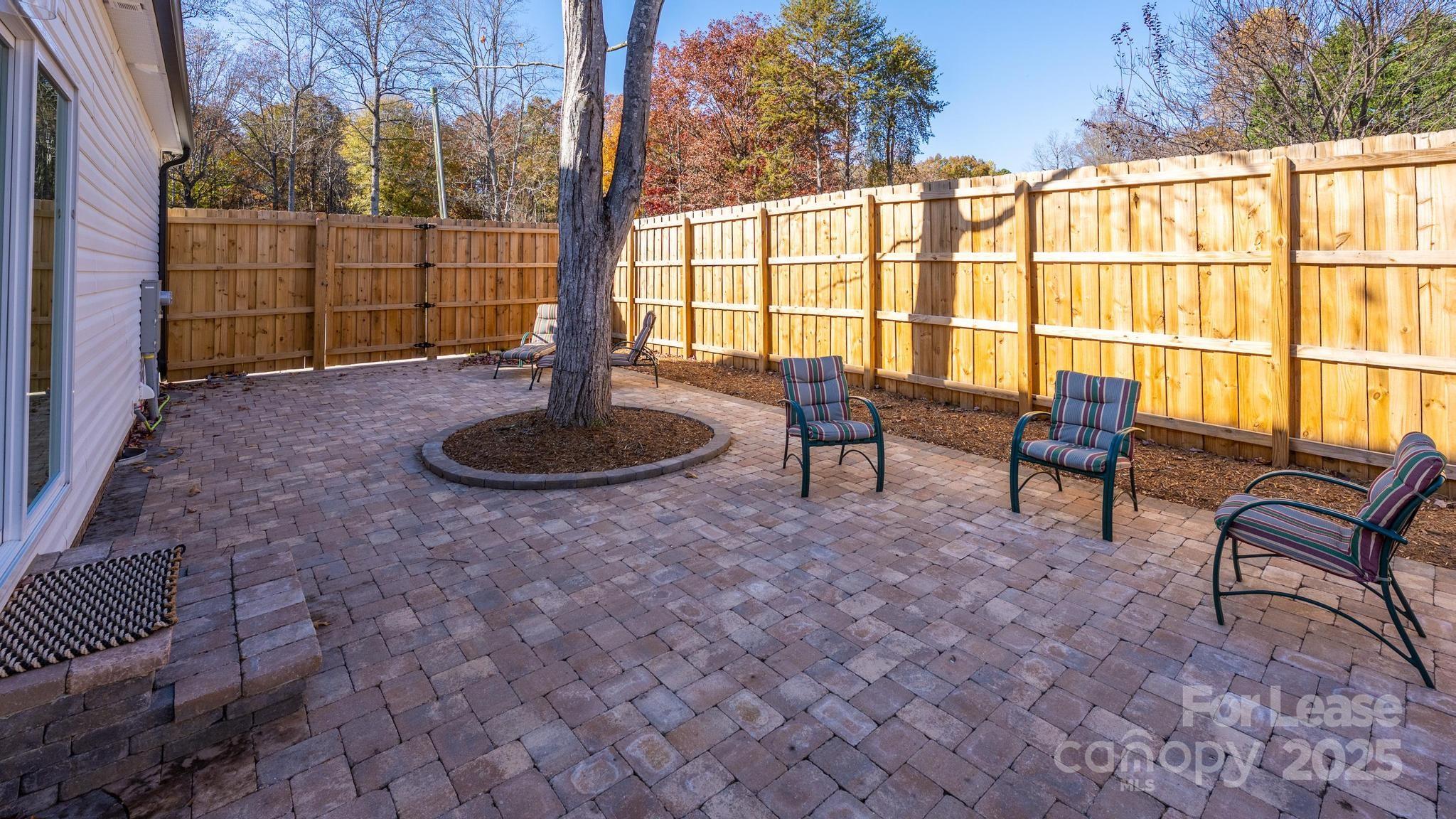 7039 Executive Circle Denver, NC 28037 - Photo 38 of 48 a living room with furniture and a floor to ceiling window