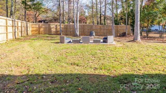 a view of fountain in the backyard of house with large tree