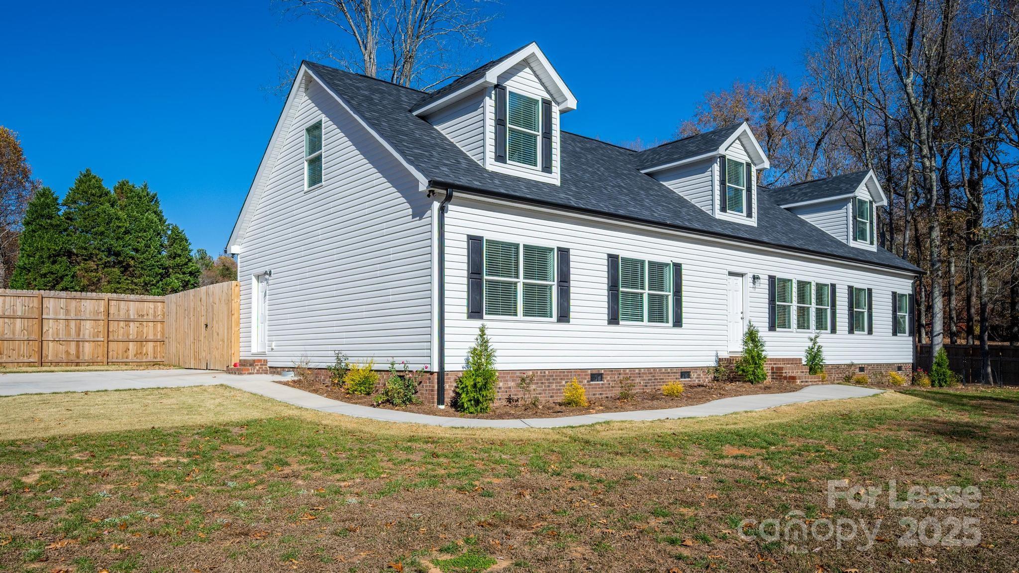 7039 Executive Circle Denver, NC 28037 - Photo 47 of 48 a front view of a house with a yard
